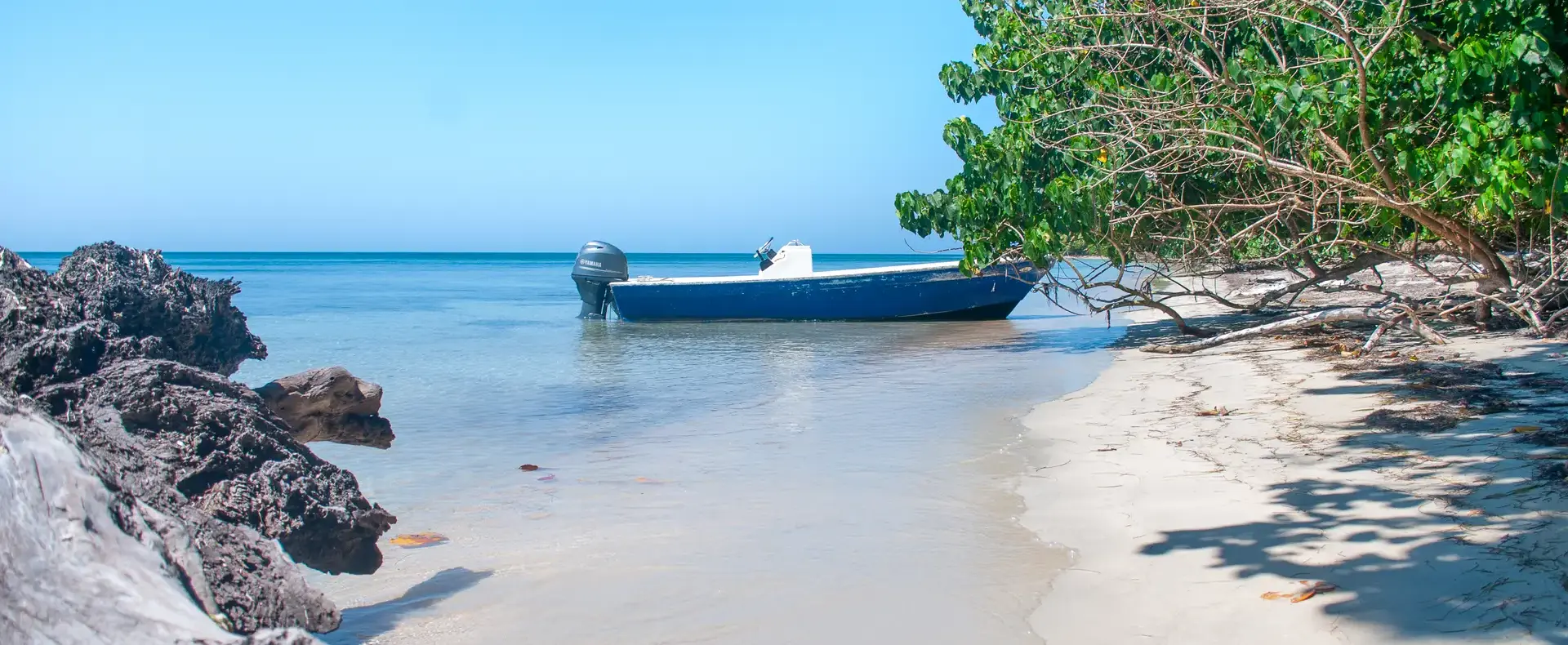 Boat moored at a rocky beach, Guanaja