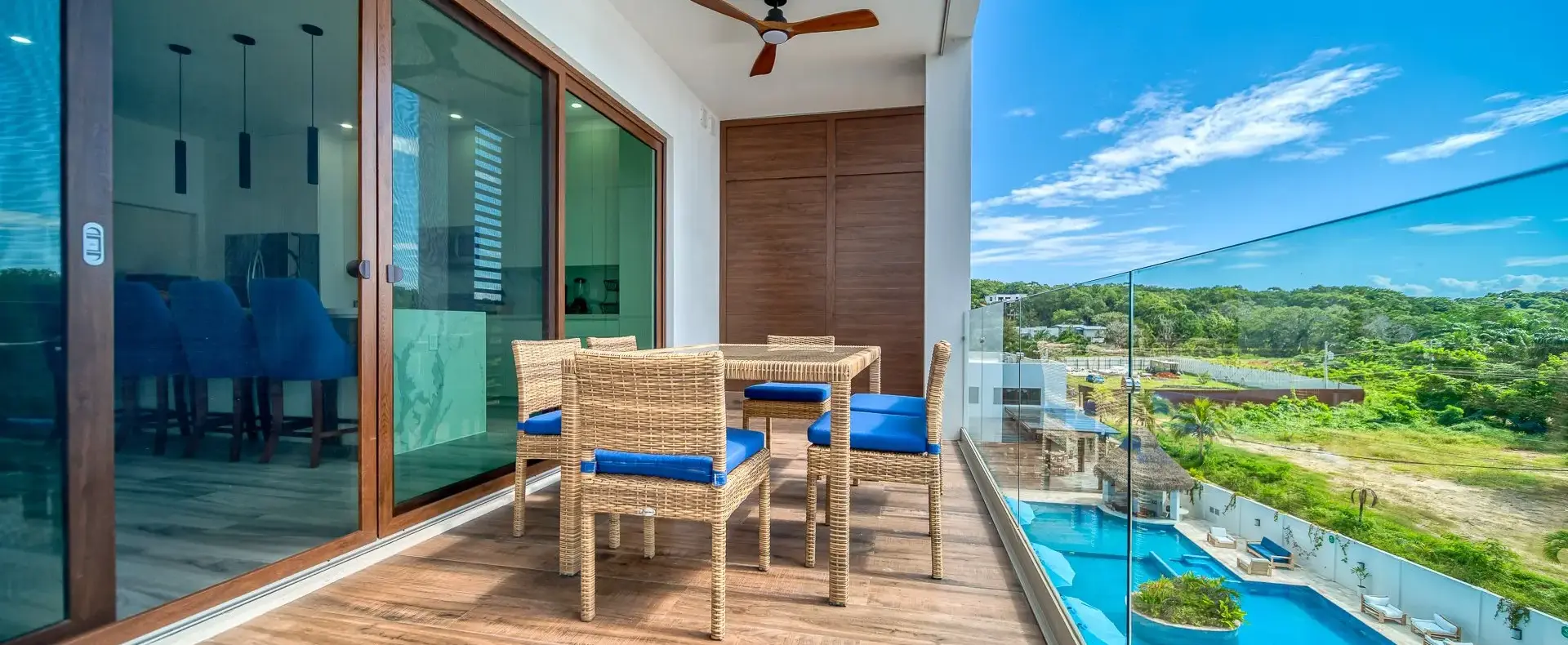 Balcony dining area with pool view, Acqua di Mare condo, West Bay