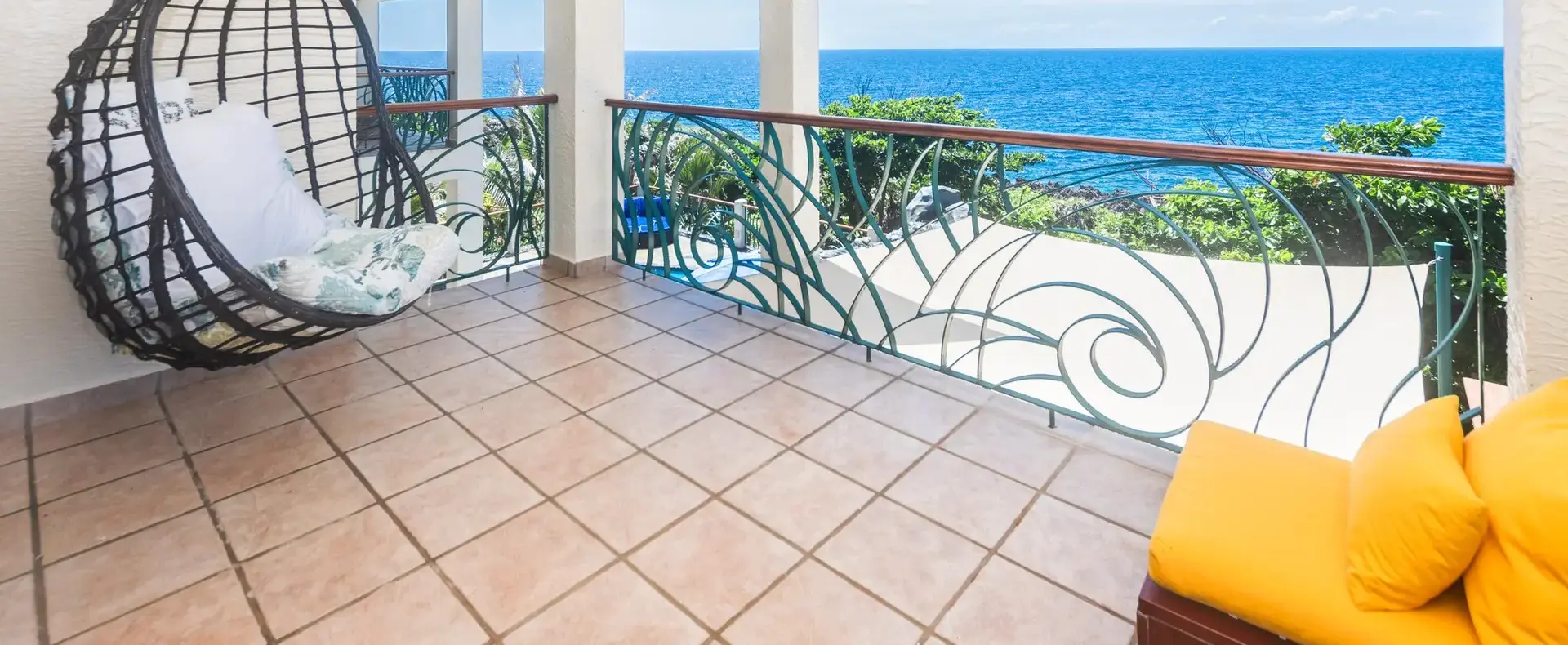 Balcony with hanging chair and Caribbean Sea view