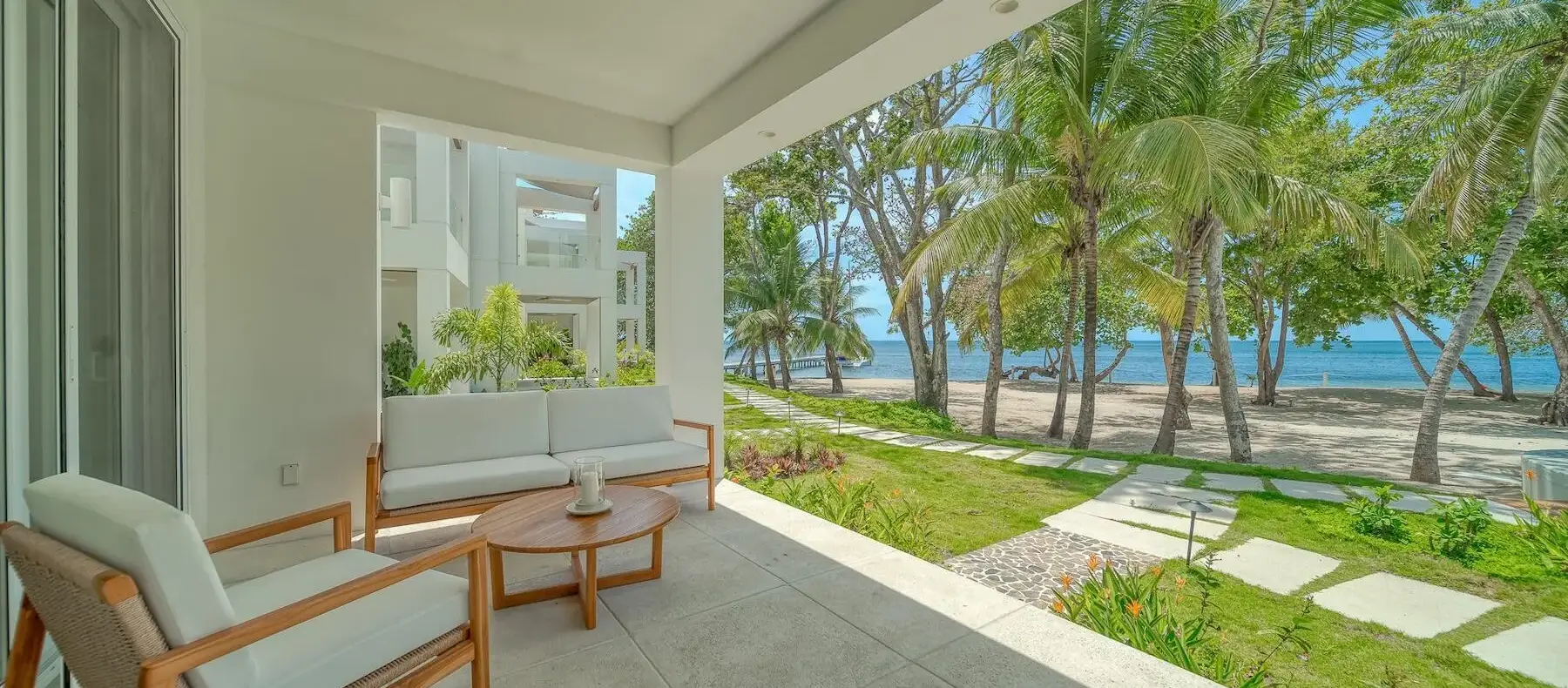 Covered ground-floor terrace with view of the garden and beach (sample unit)