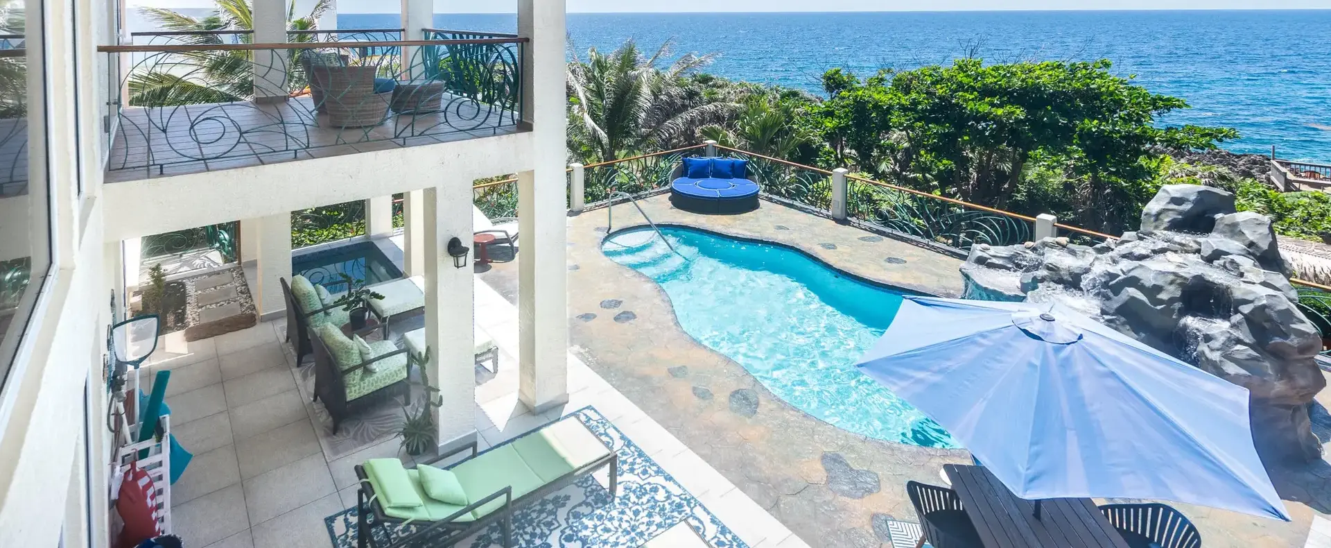 Covered terrace with lounge chairs overlooking the pool