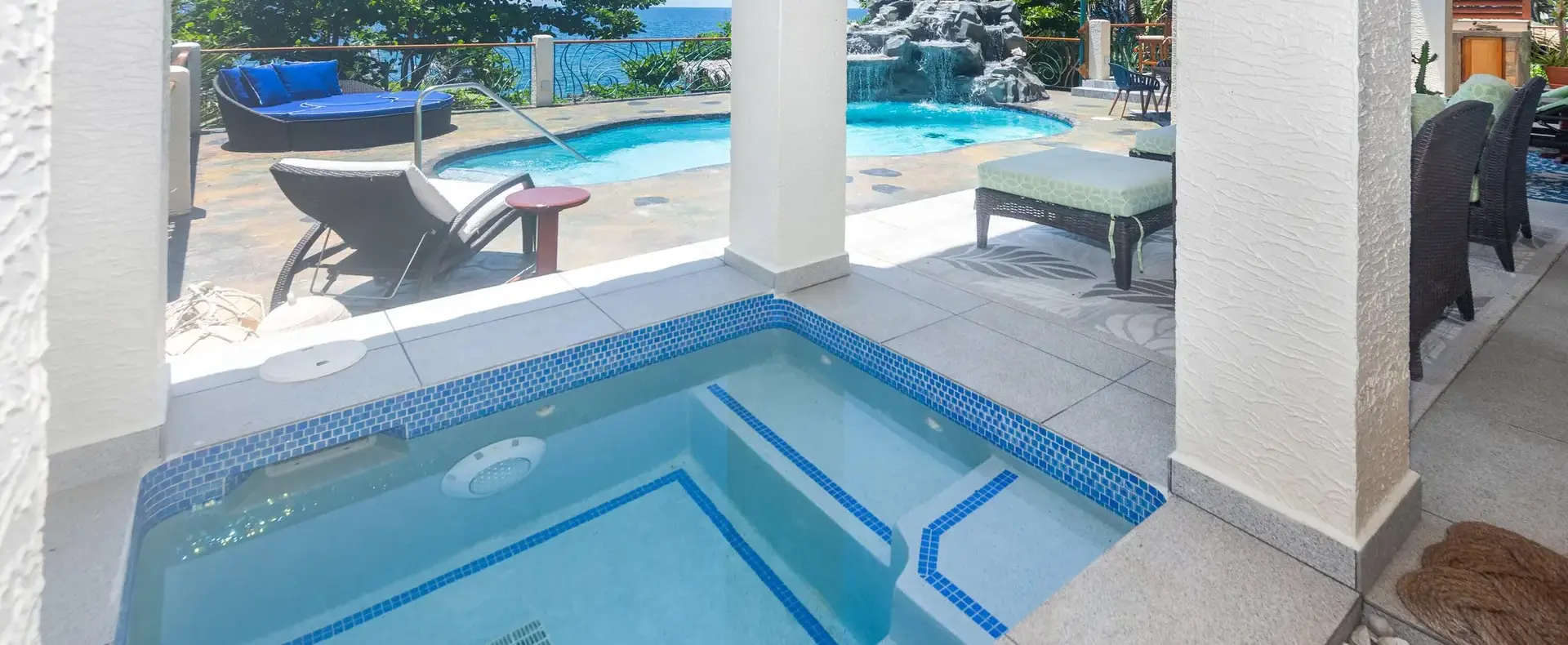Hot tub on the covered patio next to the pool