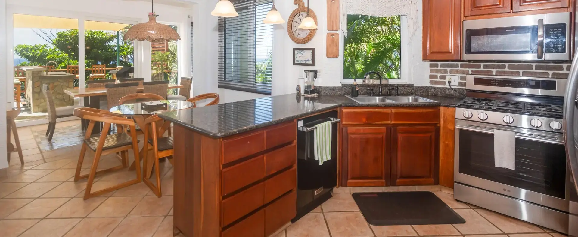 Kitchen with granite island, hardwood cabinets and stainless-steel appliances