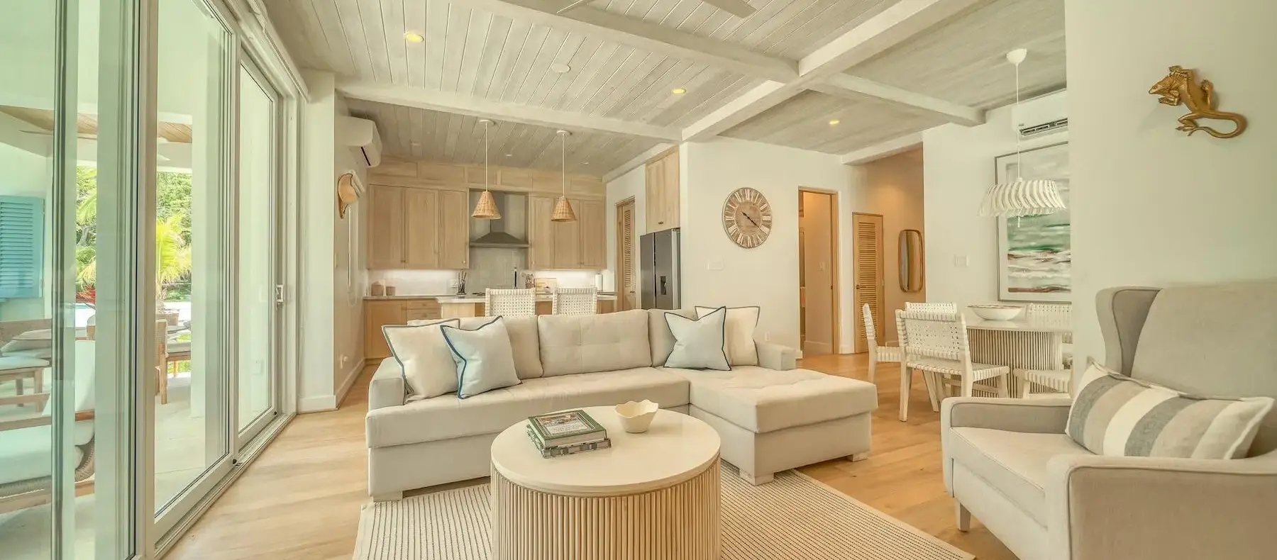 Living room with light wood floors in a West Bay condo at Watercolors (sample unit)