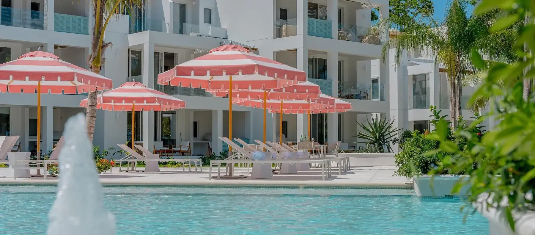 Pool fountain and umbrellas in front of the Watercolors buildings