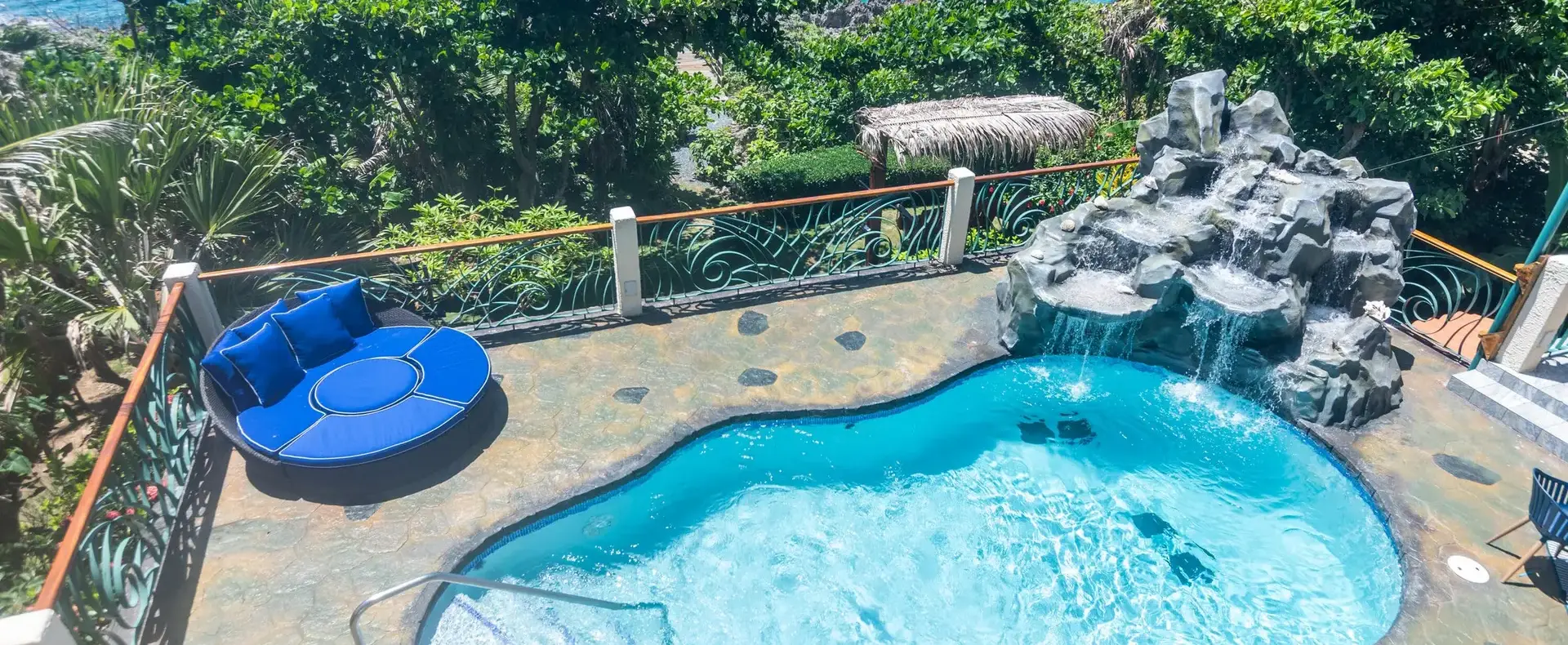 Pool and rock waterfall with Caribbean Sea view at Casa Cascada