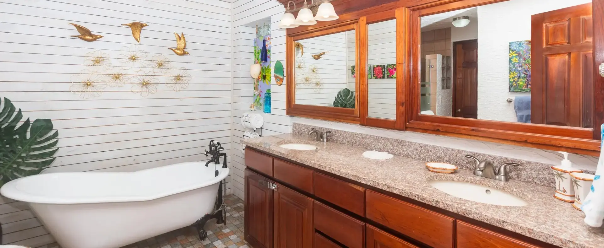 Primary bathroom with clawfoot tub and double vanity
