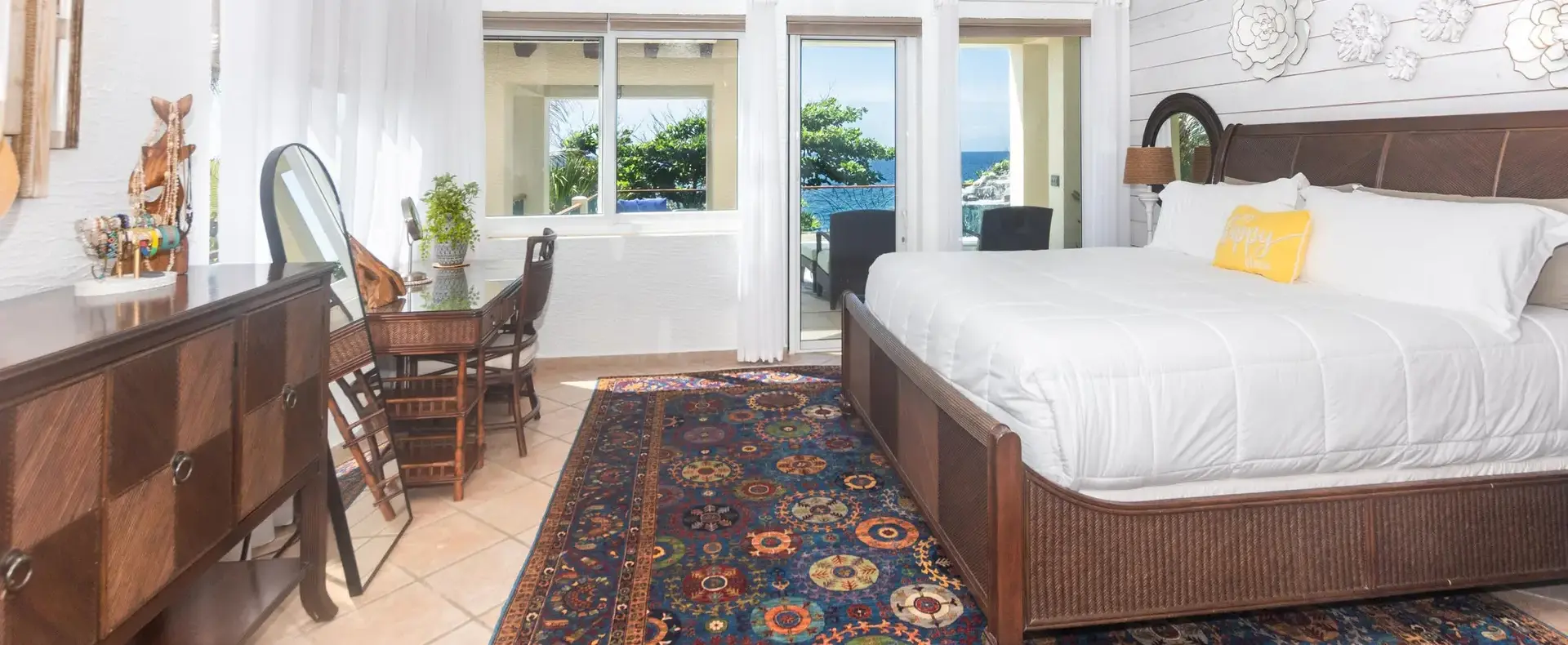 Primary bedroom with king bed and view toward the pool and ocean