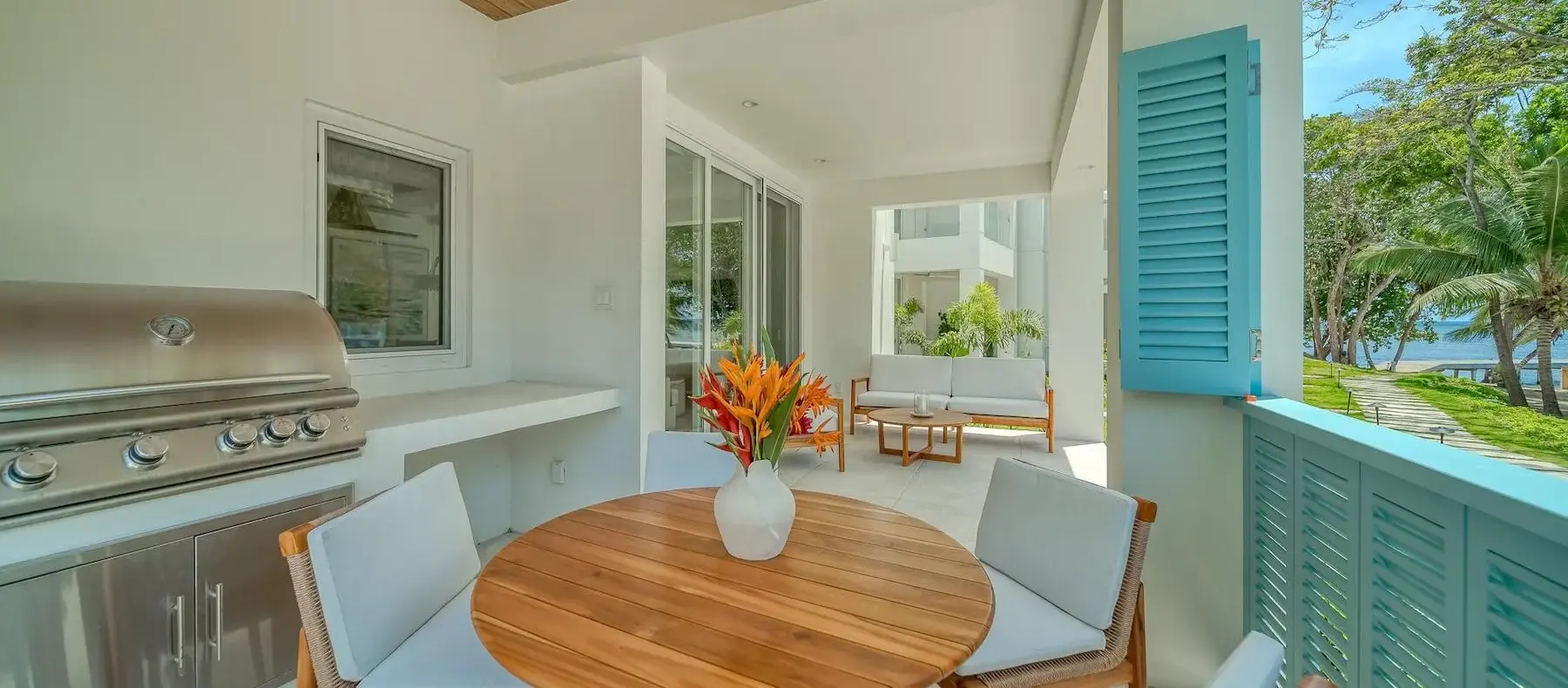 Covered terrace with dining table and built-in grill (sample unit)